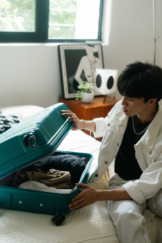 How to use 7 piece packing cubes, traveller sorting clothes into an open suitcase